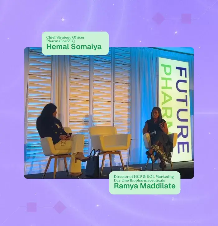 Photo of two women sitting in chairs on a stage at a conference, with names and affiliations in text overlaid on the photo